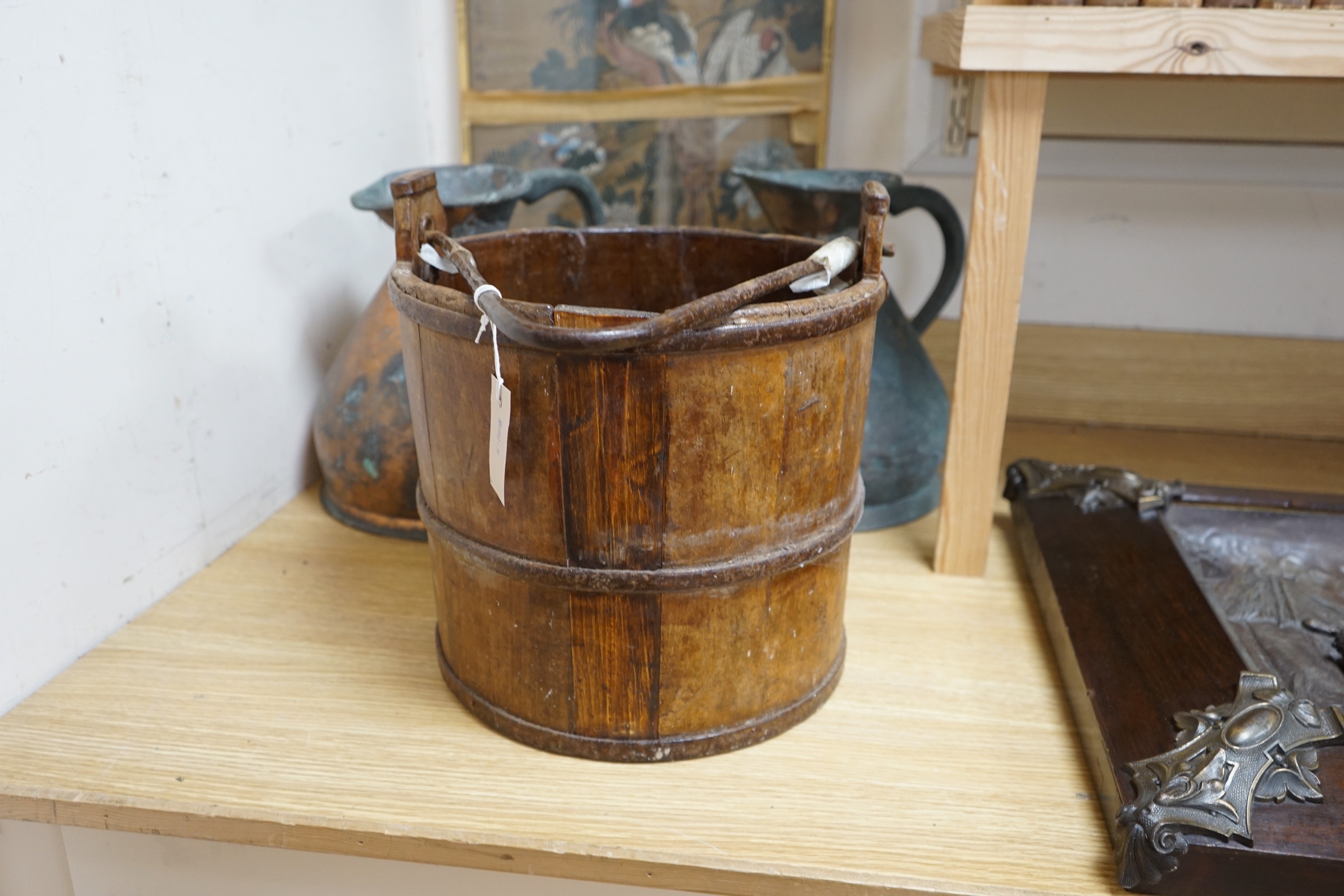 Two Victorian two gallon copper haystack measures and a wooden well bucket, Tallest 35cm